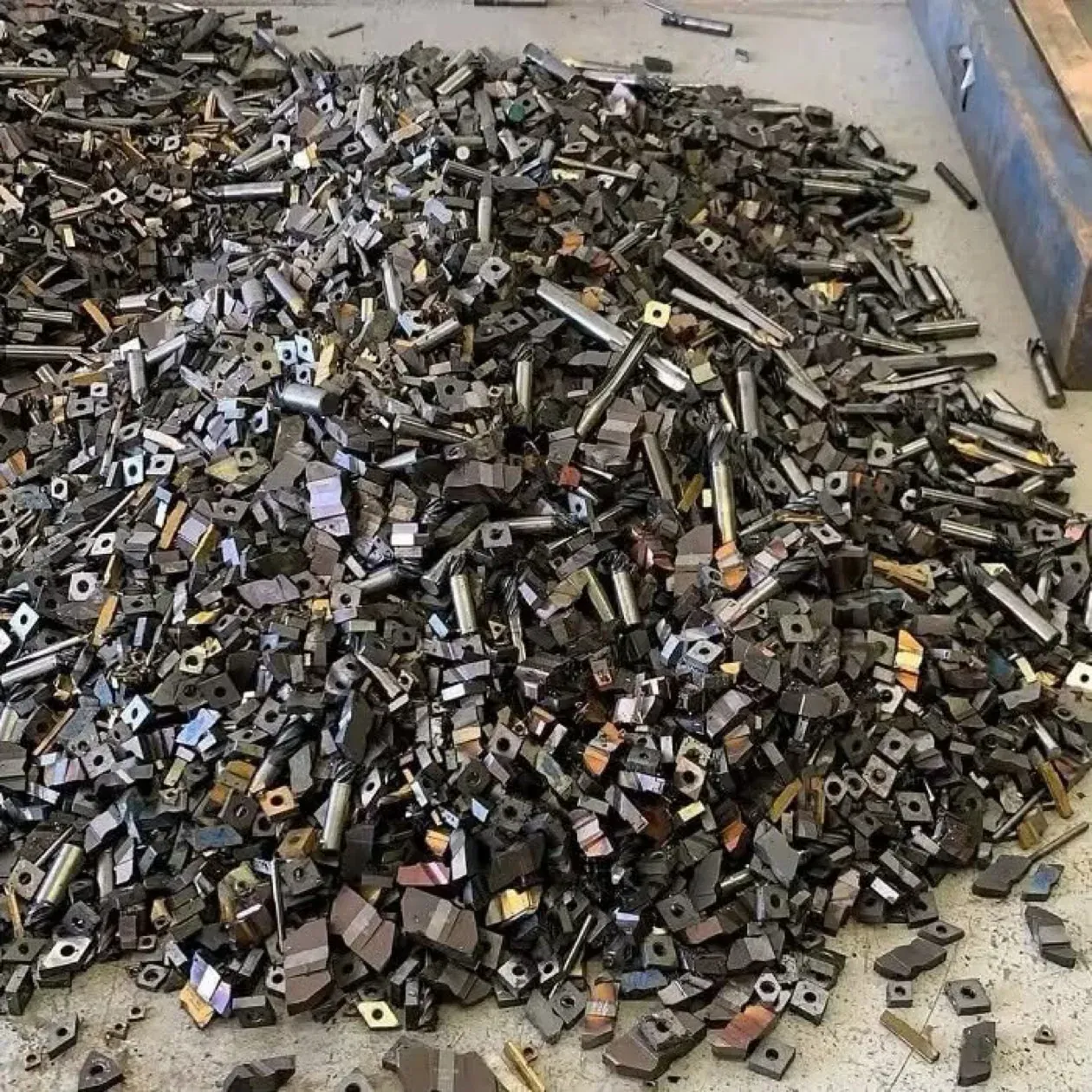 Pile of mixed tungsten carbide scrap tooling bought by Ironcrest