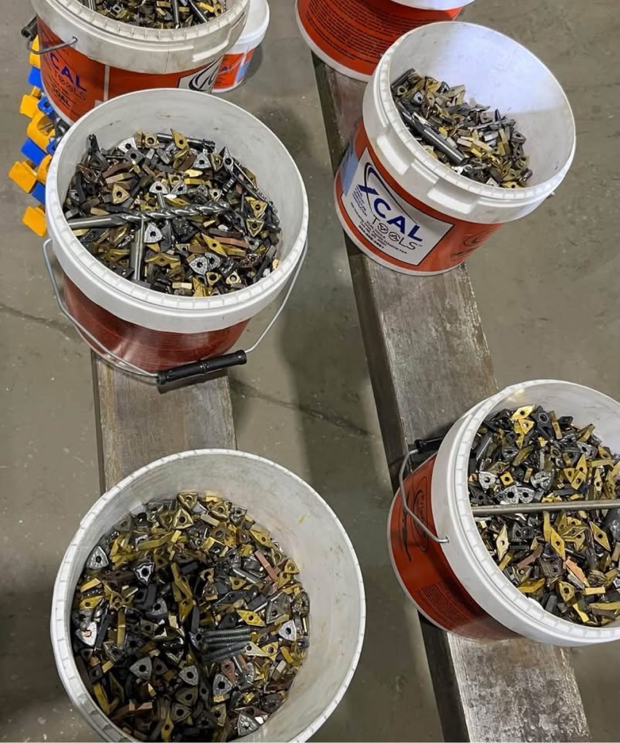Buckets of used carbide inserts